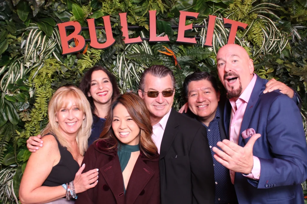 Bulleit brand activation event in front of a lush greenery photo backdrop