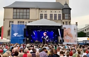 Corporate outdoor event activation with live stage performance and audience engagement