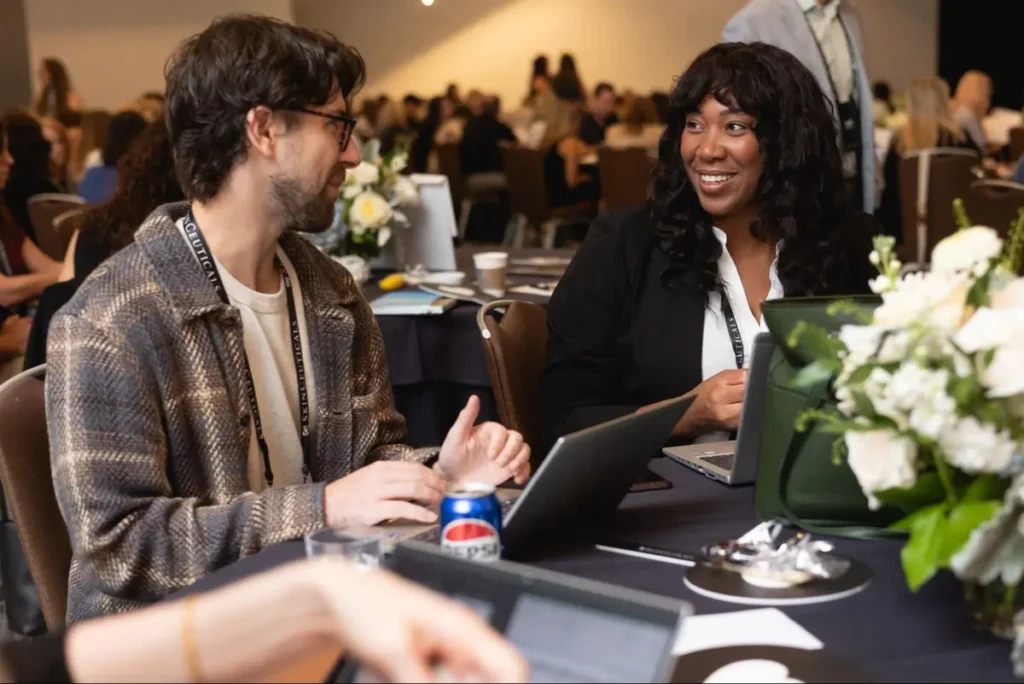 Colleagues networking and discussing ideas at a corporate event table