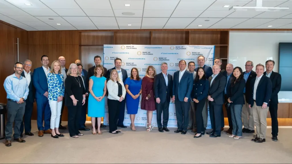 Corporate professionals posing for a group photo at a networking event