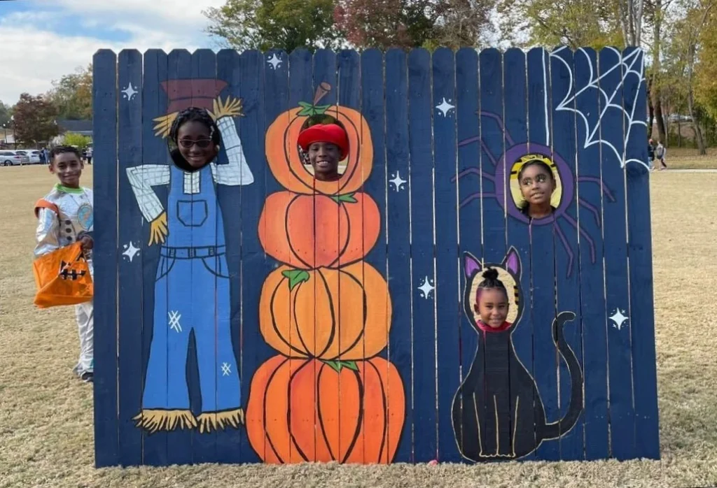 Pumpking night themed cutout Photo Booth backdrop with face cutouts.