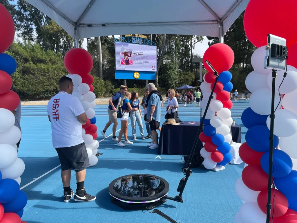 USATF Event booth with balloon decorations at an outdoor venue