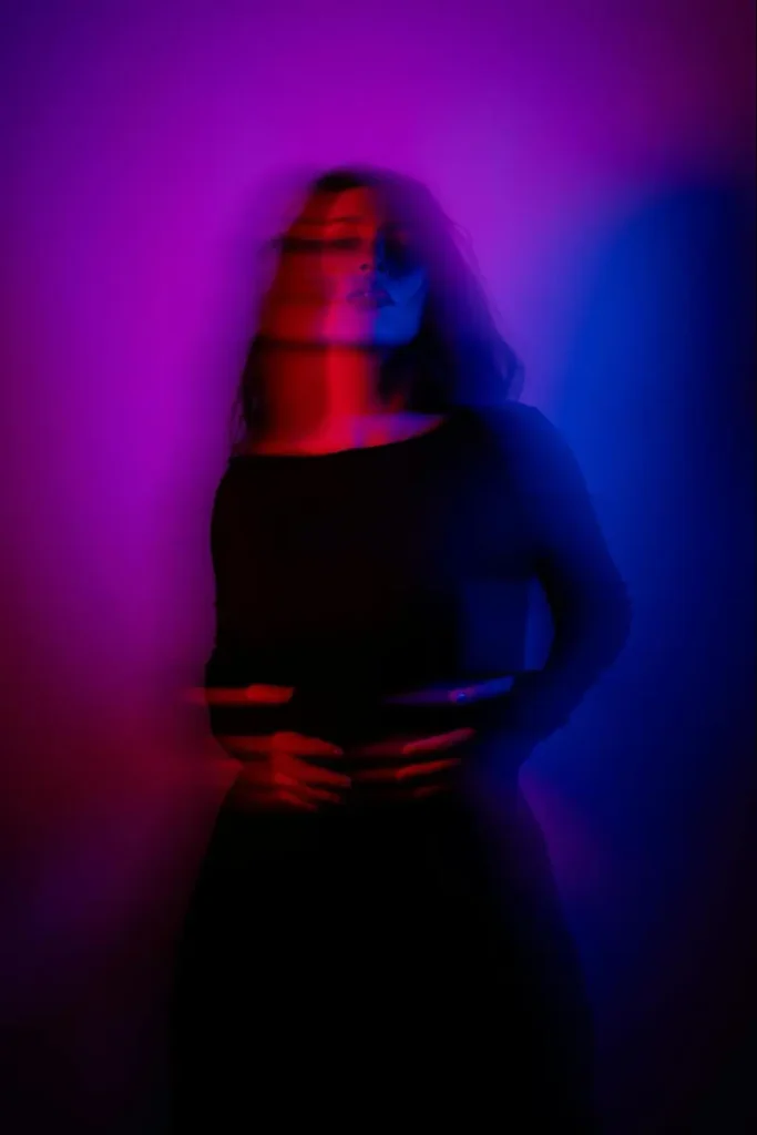 Artistic portrait with neon lighting effects showing silhouette in red and blue, demonstrating modern color gradient trends