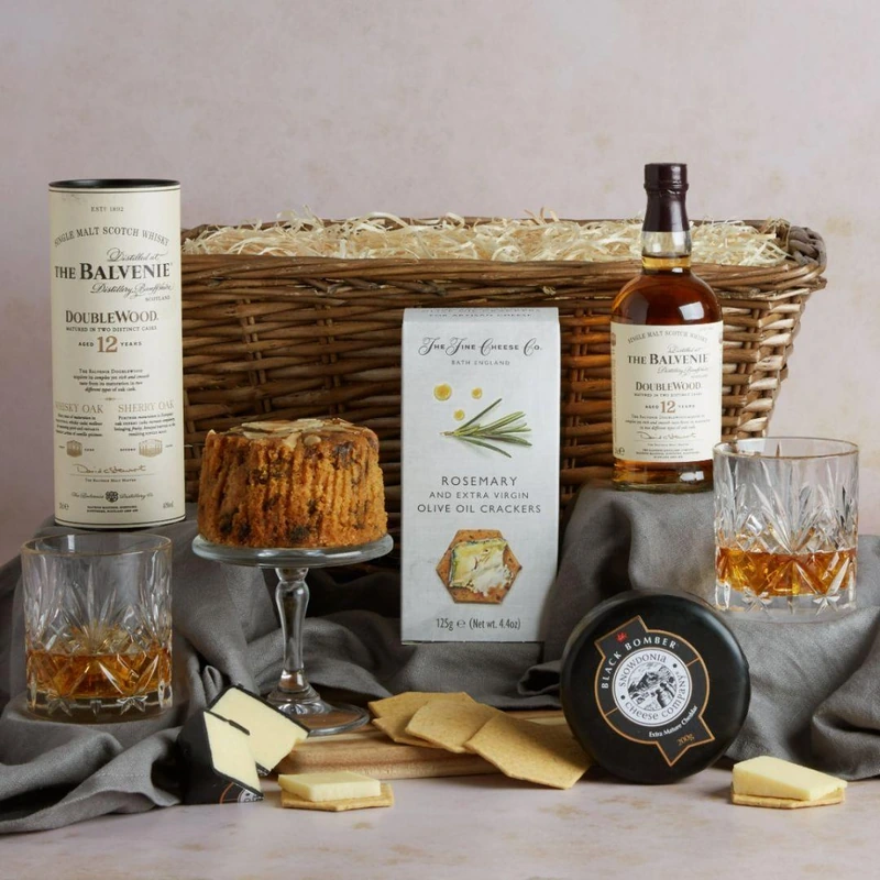 Luxury whiskey gift basket with Balvenie scotch, crystal glasses, gourmet crackers, and artisanal cheese