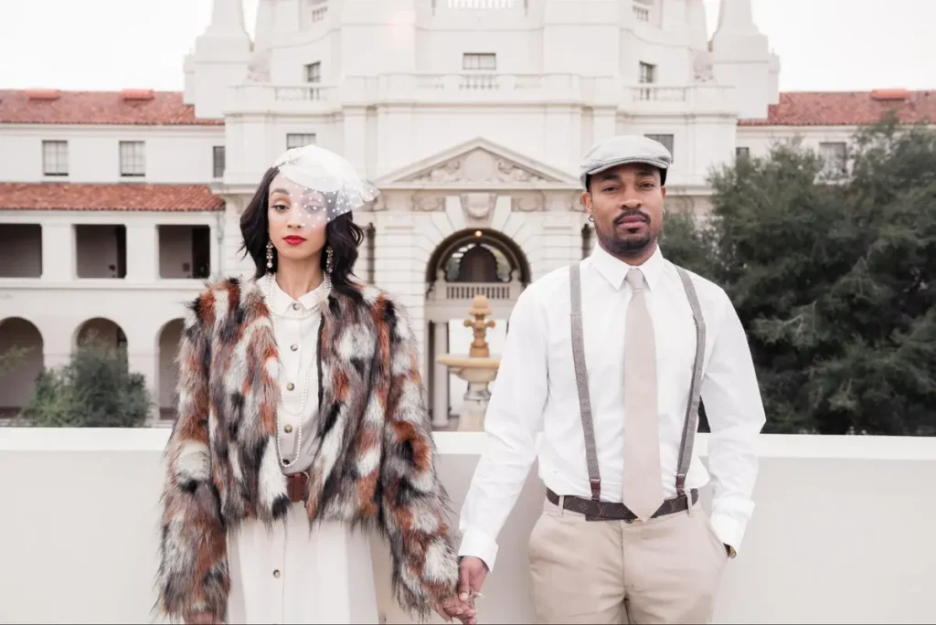 Vintage-inspired fashion photography with couple in retro attire posing in front of historic building - period aesthetic trend