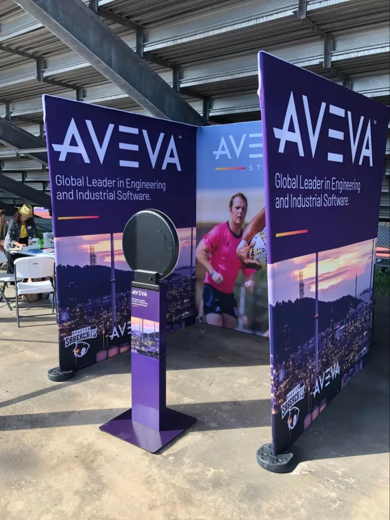 AVEVA corporate branded photo booth display with purple panels highlighting 'Global Leader in Engineering and Industrial Software