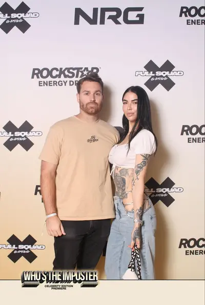 Attendees at gaming event posing against consistent branded backdrop with Rockstar Energy and FullSquad Gaming logos for photo activation