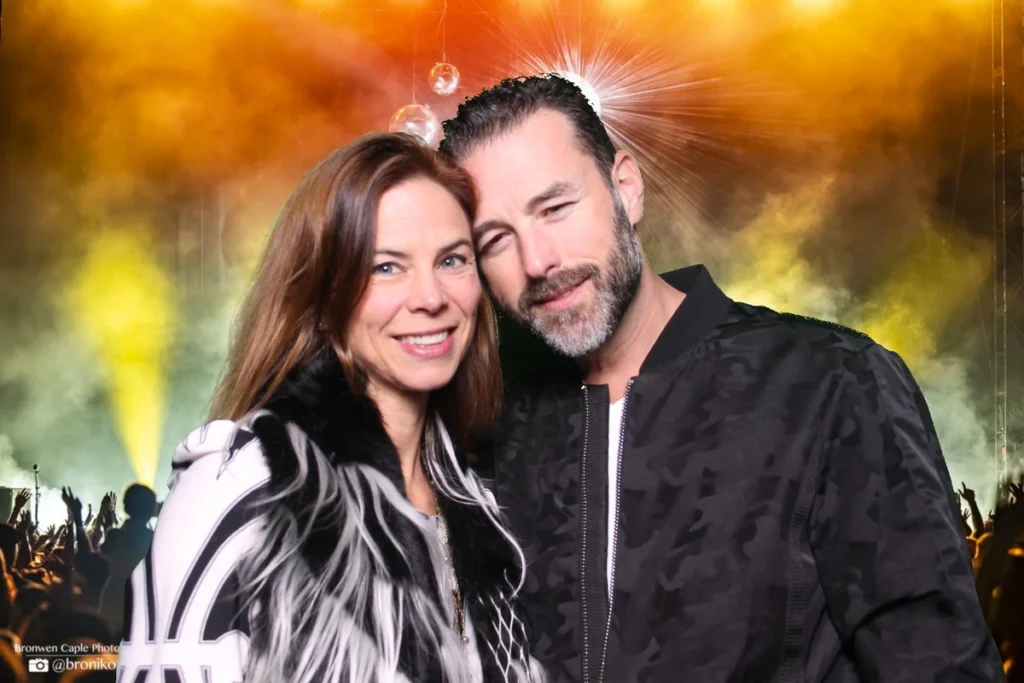 Couple at an event with AI-enhanced background showing concert atmosphere, created with photo activation technology