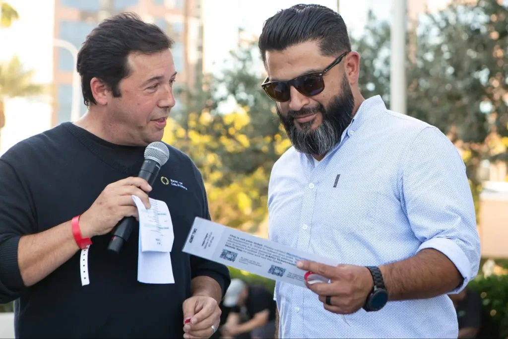 Event host interviewing participant during outdoor corporate event activity, engaging attendees with interactive Q&A experience