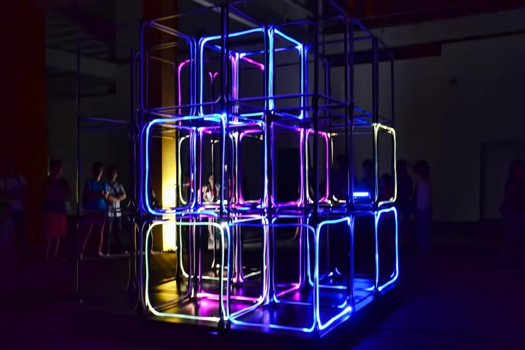 Interactive light cube installation at corporate event with neon LED lighting, creating an immersive art experience for attendees