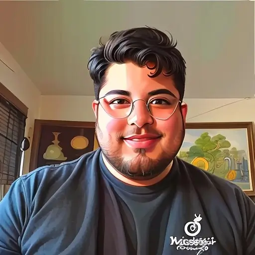 Person wearing glasses and a dark blue shirt with a logo, smiling at camera in what appears to be a home setting