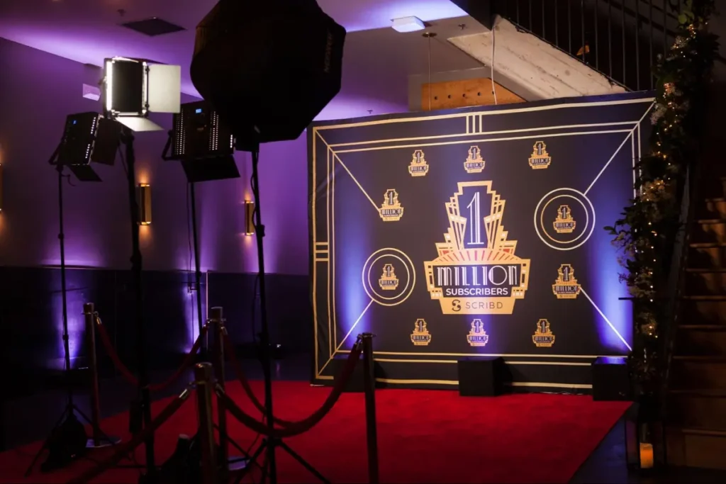 Scribd's 1 million subscribers celebration backdrop with professional lighting and red carpet setup for corporate milestone event