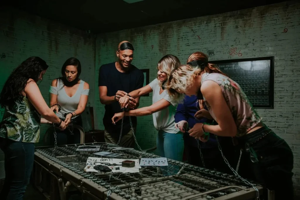 Team-building escape room experience with colleagues collaborating to solve puzzles, fostering teamwork in immersive environment