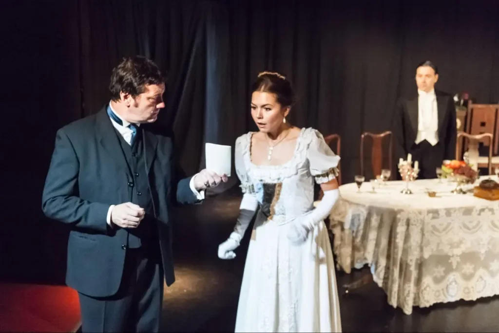 Theatrical performance with actors in period costumes at a formal dinner table - corporate entertainment through live performances