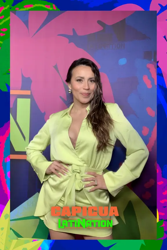 Woman in lime green outfit posing against colorful digital backdrop with 'CAPICUA LATINATION' text, showcasing AI-enhanced photo frame