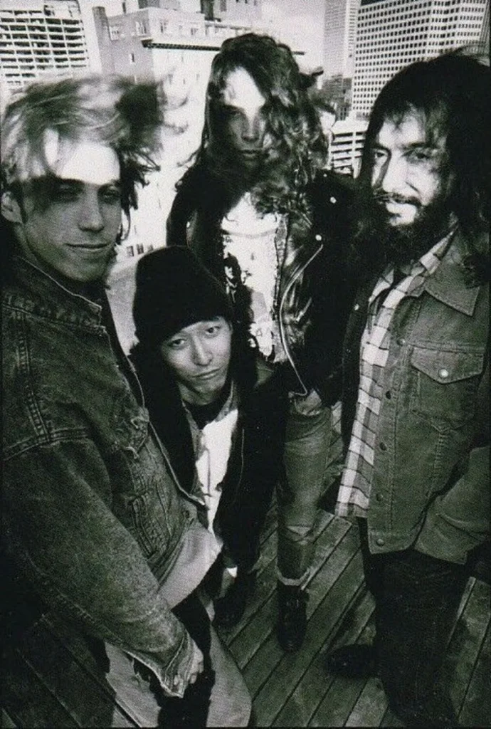 Black and white portrait of a four-person rock band with vintage aesthetic, ideal for music-themed events