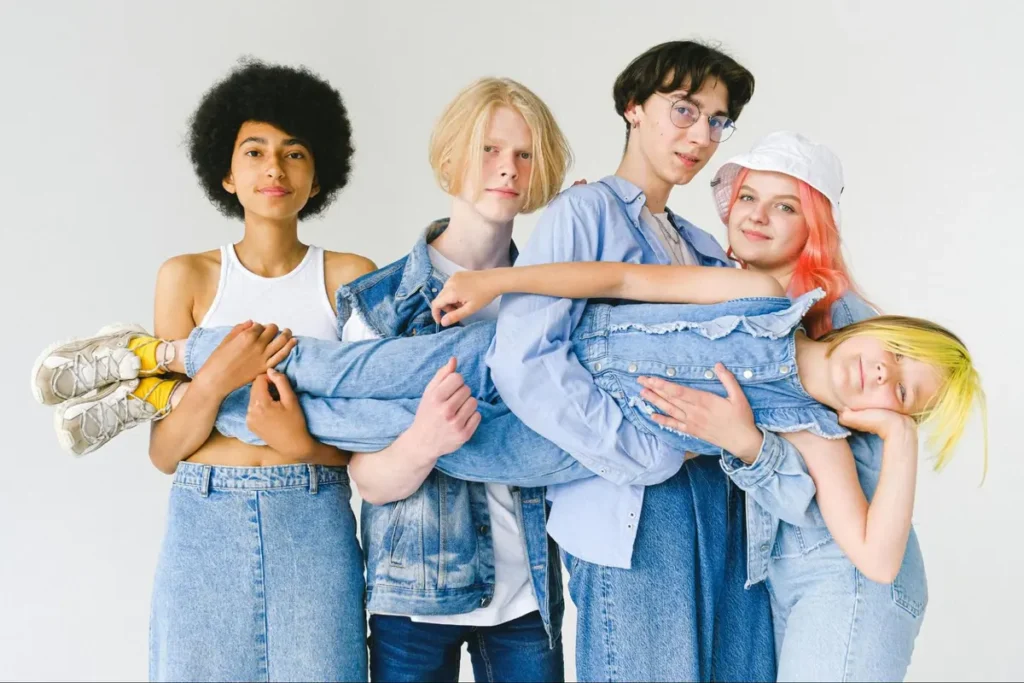 Diverse group of young people in denim outfits posing together, great for fashion show or youth culture themed events