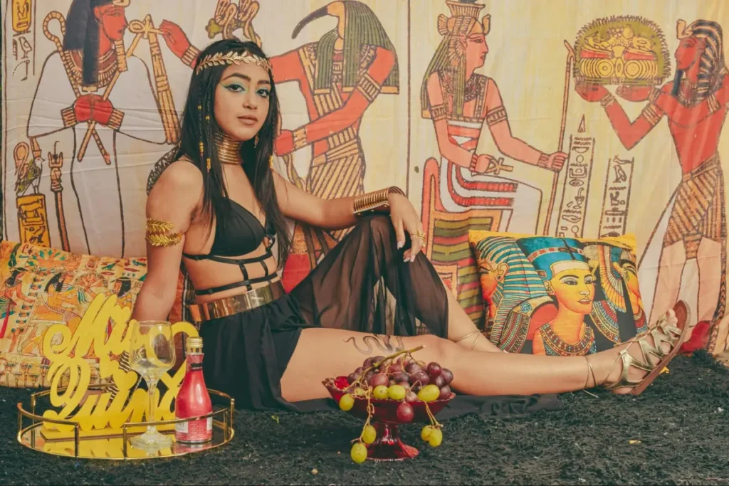 Egyptian-themed costume party with Cleopatra-inspired styling, hieroglyphic backdrop, and authentic decorative elements