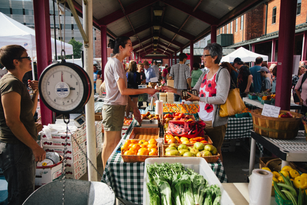 Farmer's market themed event with fresh produce stall, vendor interaction and seasonal fruits perfect for farm-to-table gatherings