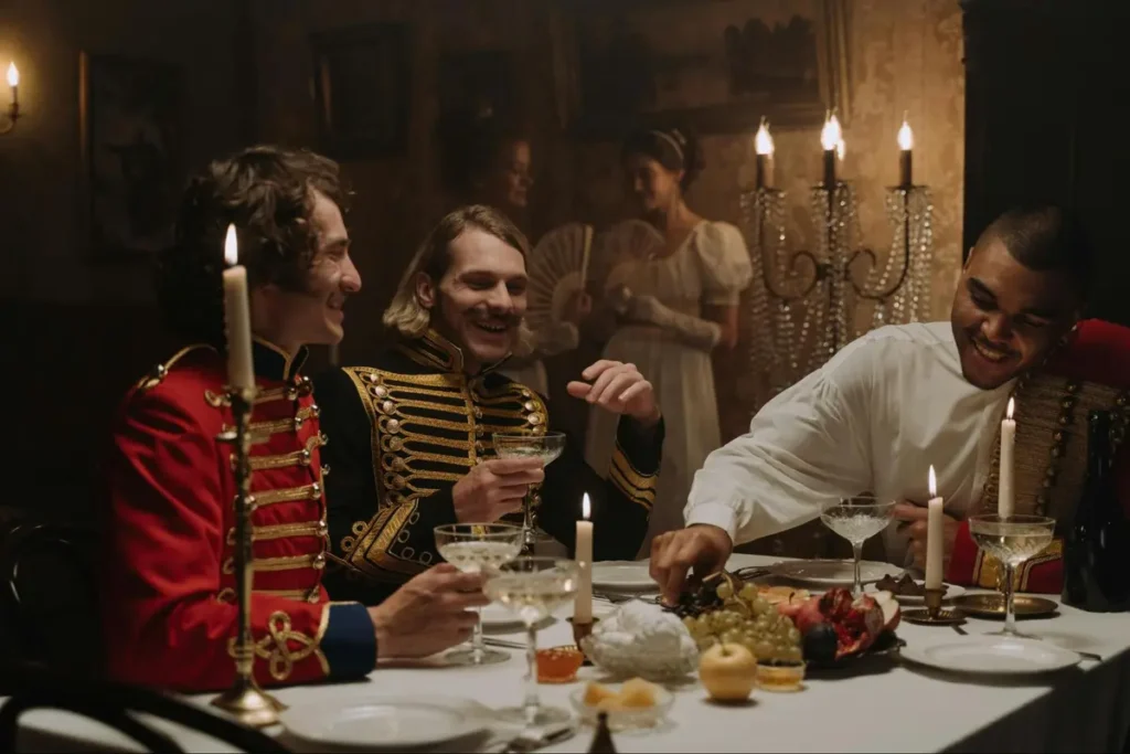 Historical military regency ball with gentlemen in period military uniforms enjoying dinner by candlelight