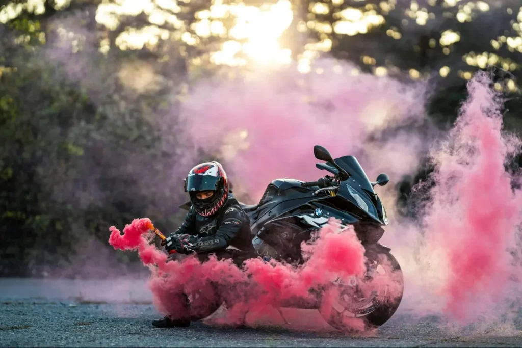 Motorcyclist with vibrant pink smoke bombs creating dramatic effect, ideal for extreme sports or action-themed events