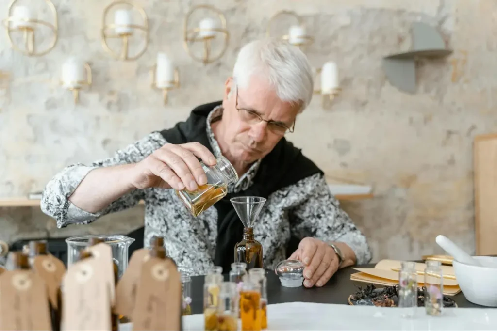 Perfumer or mixologist carefully measuring and combining ingredients for a fragrance workshop or cocktail masterclass