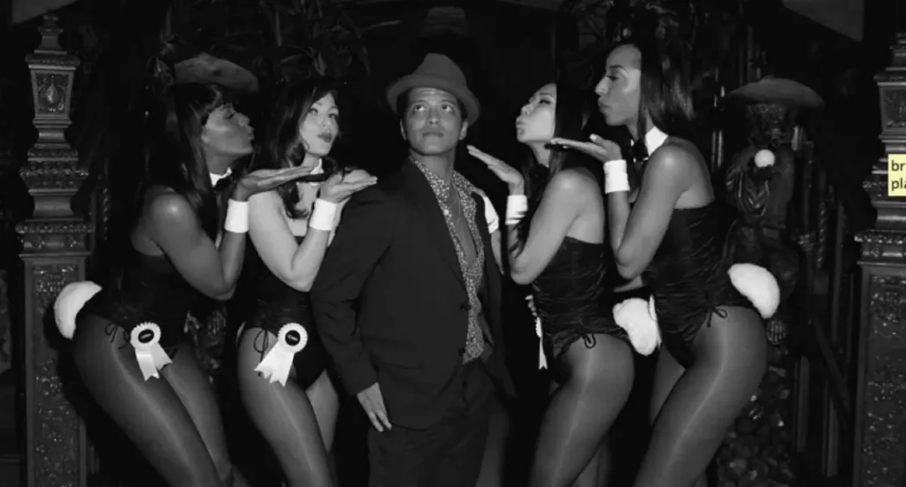 Playboy-inspired vintage party with models in bunny costumes surrounding gentleman in formal attire for retro-themed events