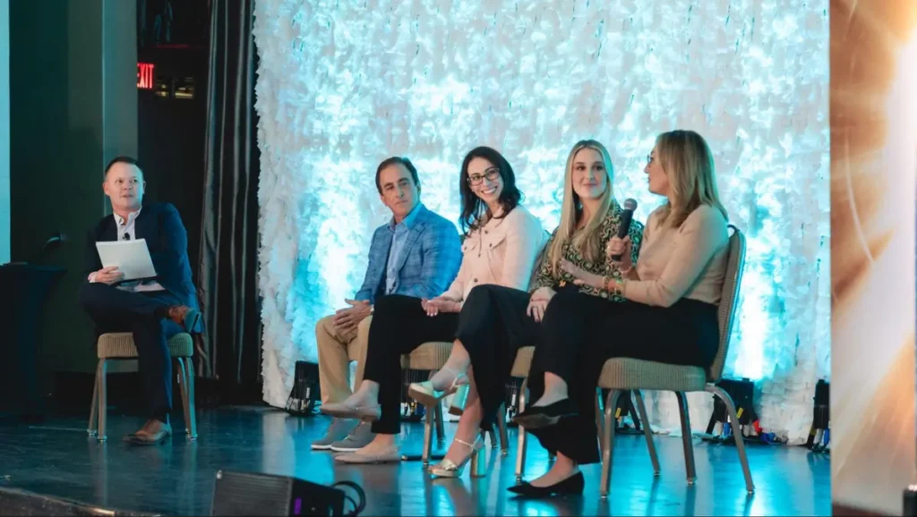 Professional panel discussion with speakers on stage - Industry conference or thought leadership event with expert panelists