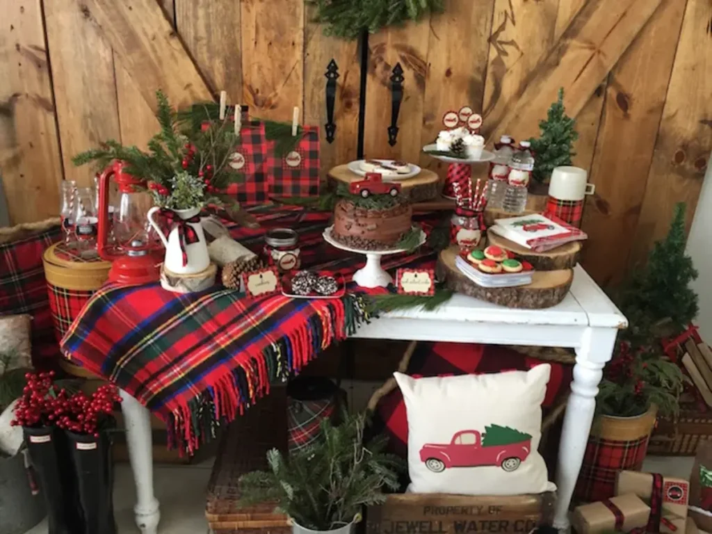 Rustic lumberjack holiday party dessert table with buffalo plaid, vintage elements and woodsy decorations