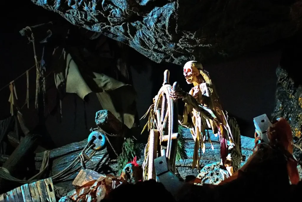 Spooky skeleton ship captain display from a pirate-themed haunted attraction or Halloween event setup